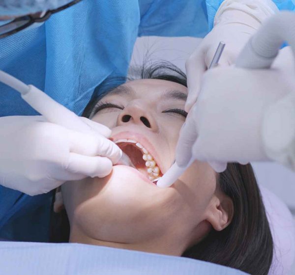 Dentist at LAF Dental Studio treating a patient with care Dentist at LAF Dental Studio treating a patient with care
